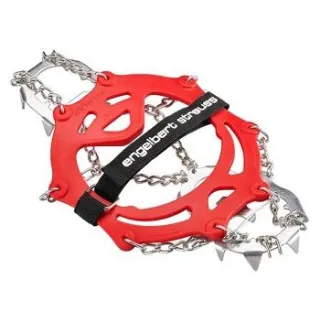 Czerwone łańcuchy na buty z metalowymi kolcami i czarnym paskiem z napisem. Produkt przeznaczony do zwiększenia przyczepności na śliskich powierzchniach.